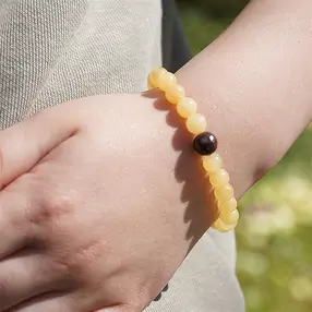 Bracelet, calcite orange, os de dinosaure, 14cm (pour enfants) | Marco Schreier