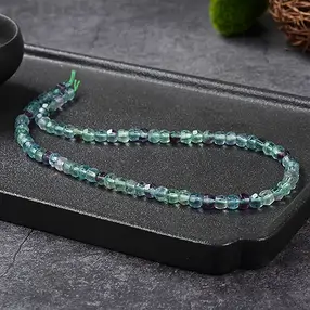 Button strand, fluorite, 05 x 06mm, faceted | wholesaler gems & healing stones