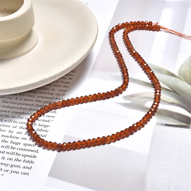 Button strand, Hessonite (garnet), faceted, 03 x 04mm (39cm) | Marco Schreier