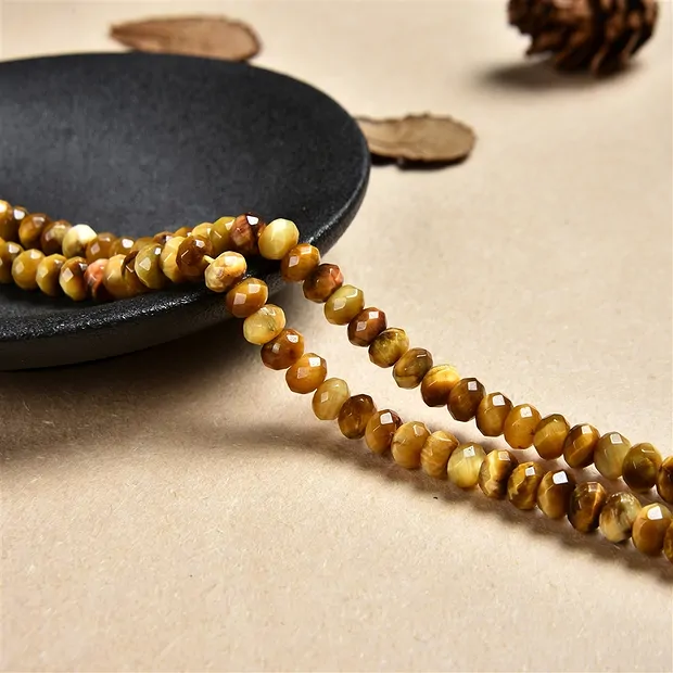 Filo di bottoni, Occhio di tigre (giallo), sfaccettato, 05 x 08 mm (38 cm) | Marco Schreier