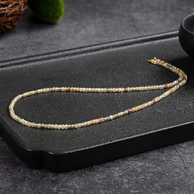 Button strand, Zircon (natural, gold-brown), faceted, 02 x 03mm | Marco Schreier