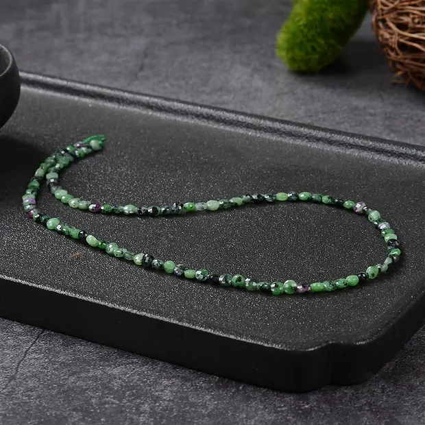 Strand Coin, Zoisite with Ruby, 04 x 02mm, faceted (39cm) | Marco Schreier