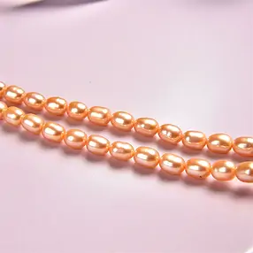 Rang de collier grain de riz, perle d'eau douce, jaune d'or (teintée), 06-07 x 05-06mm | Marco Schreier