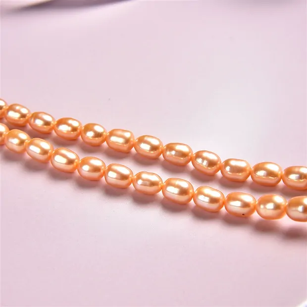 Strand of rice grain, freshwater pearl, golden yellow (dyed), 06-07 x 05-06mm | Marco Schreier