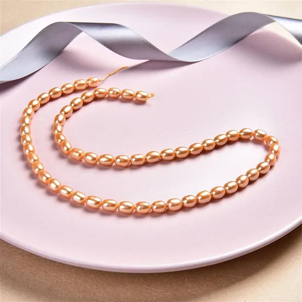 Strand of rice grain, freshwater pearl, golden yellow (dyed), 06-07 x 05-06mm | Marco Schreier