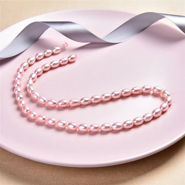 Strand of rice grain, freshwater pearl, pink (dyed), 07-09 x 06-07mm | Marco Schreier