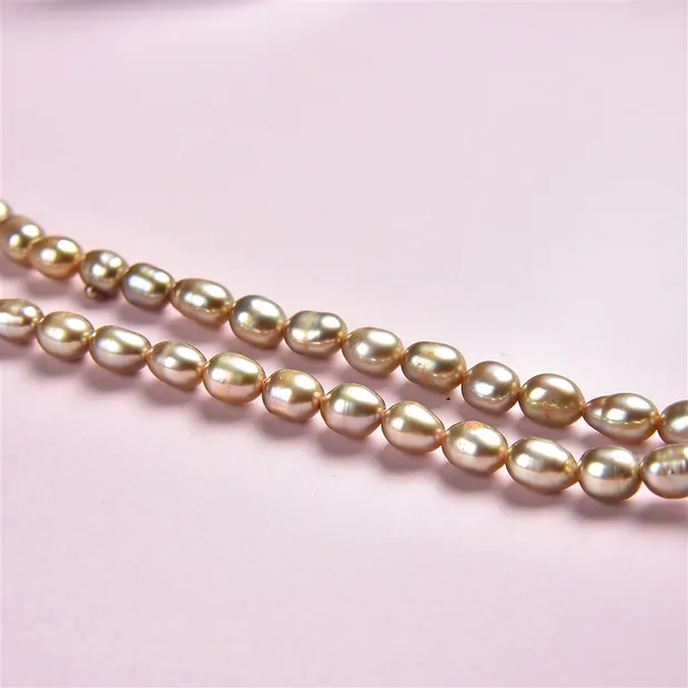 Strand of rice grain, freshwater pearl, yellow-green (dyed), 06-07mm | Marco Schreier