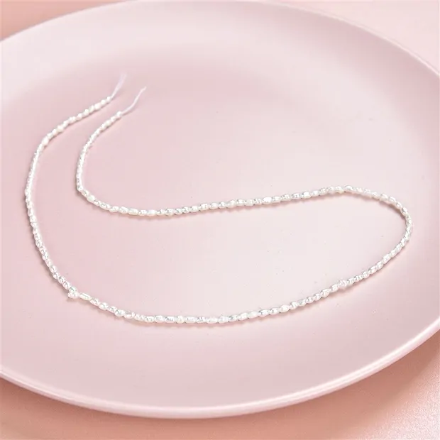 Strang Reiskorn, Süßwasser-Perle, weiß-creme, 02 - 02,3mm | Marco Schreier