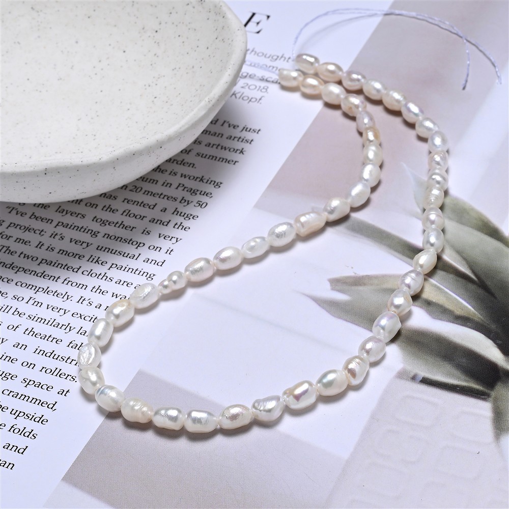 Strand of rice grain, freshwater pearl, white-cream, 07 x 05mm (39cm) | Marco Schreier