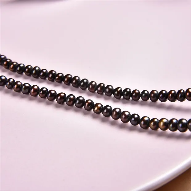 Button strand, freshwater pearl, petrol-brown (dyed), 03 x 04-05mm | Marco Schreier