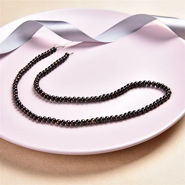 Button strand, freshwater pearl, petrol-brown (dyed), 03 x 04-05mm | Marco Schreier