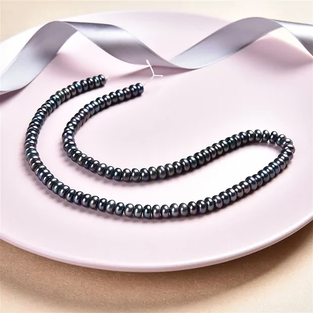 Button strand, freshwater pearl petrol (dyed), 03-04 x 05-06mm | Marco Schreier