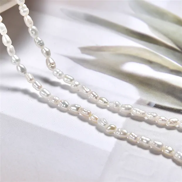 Rang de colliers Keshi, perle d'eau douce AB, blanc-crème, 09 - 12mm (39cm) | Marco Schreier