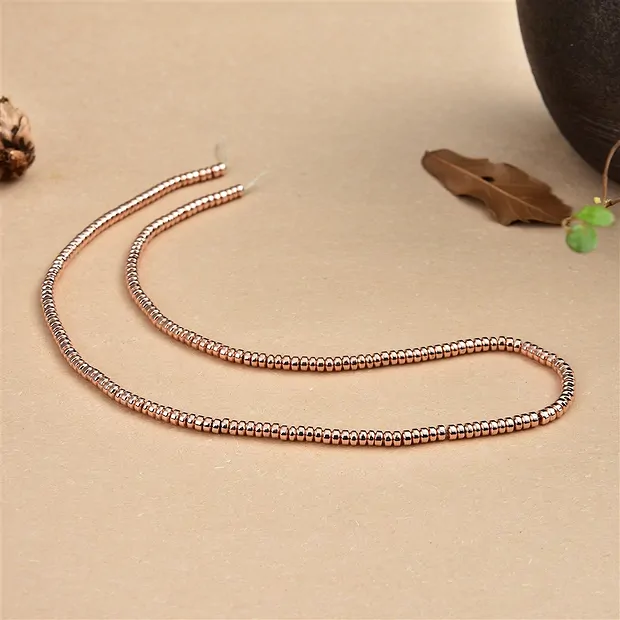 Botón de filamento, hematina oro rosa (teñido), 02 x 03mm | Marco Schreier