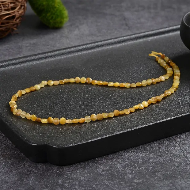 Strand Coin, Tiger's Eye (yellow), faceted, 04 x 02mm (39cm) | Marco Schreier