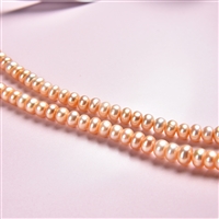 Strand button, freshwater pearl salmon (natural), 03-04 x 05-06mm